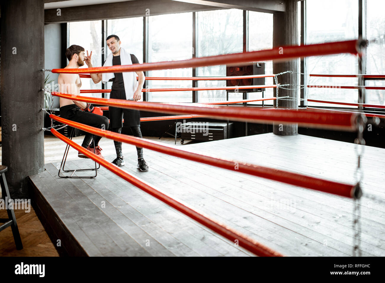 Boxing trainer giving instructions during a break motivating a boxer
