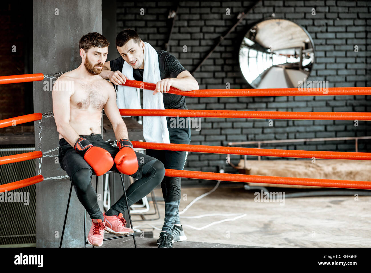 Boxing trainer giving instructions during a break motivating a boxer