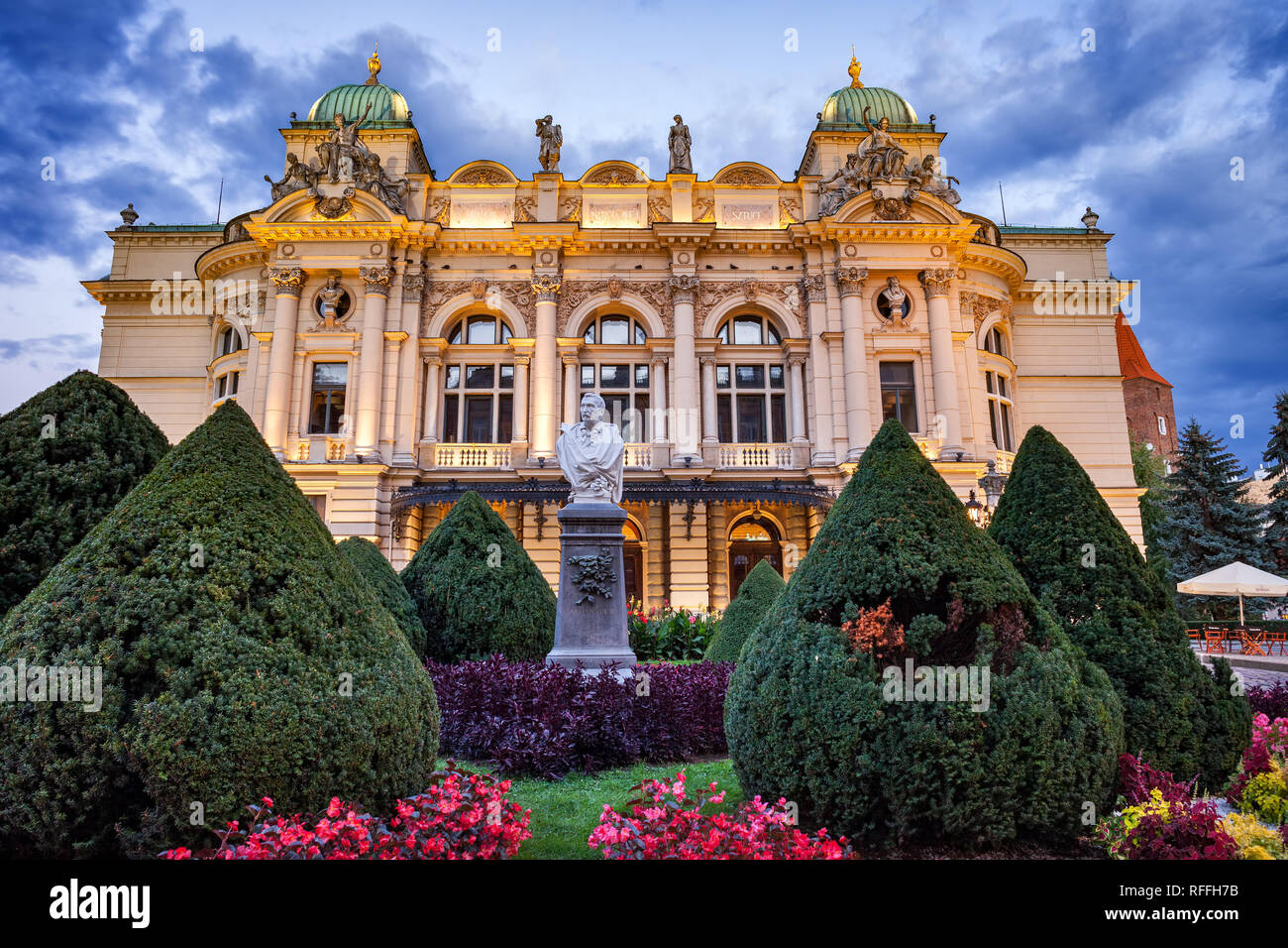 Juliusz Slowacki Theatre and Aleksander Fredro monument at dusk in Krakow, Poland. Eclectic style city landmark from 1893 with neo-baroque elements, Stock Photo