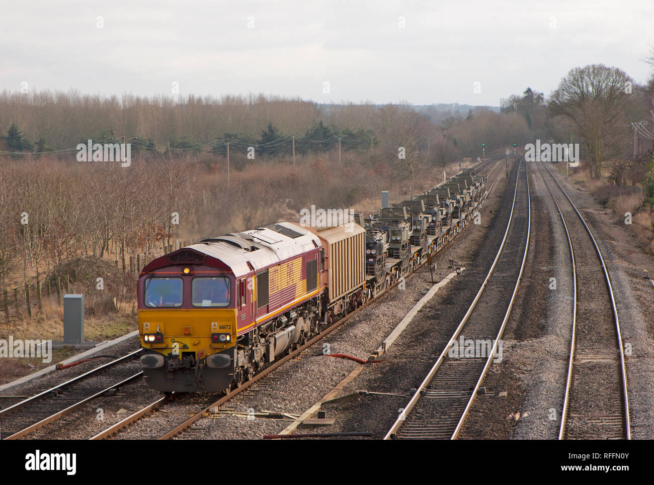 A class 66 diesel locomotive number 66172 working an MOD train loaded with military vehicles at Lower Basildon on the Great Western Mainline. Stock Photo