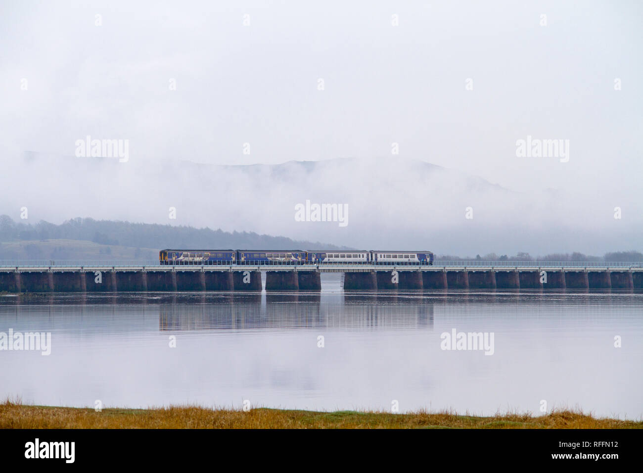 A pair of Northern Railway class 156 diesel multiple units crossing over Leven Viaduct near Ulverston. Stock Photo