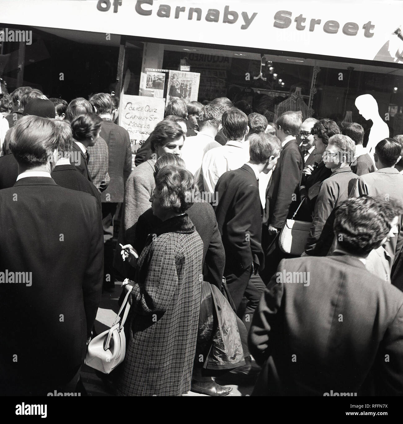 1967, historical, crowds of people mingle outside a shop in ...
