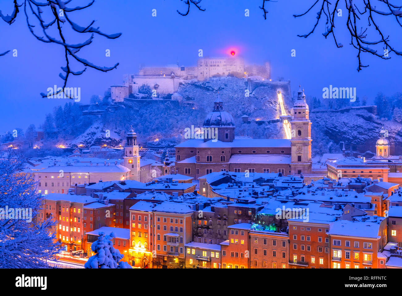 Salzburg, Austria: Heavy snow on the historic city of Salzburg with famous Festung Hohensalzburg and Salzach river in winter Stock Photo