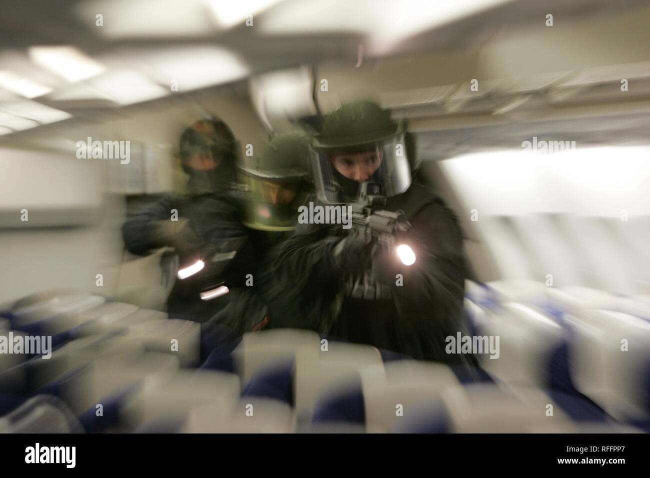 DEU, Germany, Duesseldorf : Police officers of a SWAT Team on a training misson in an airplane, in case of a highjacking. | Stock Photo