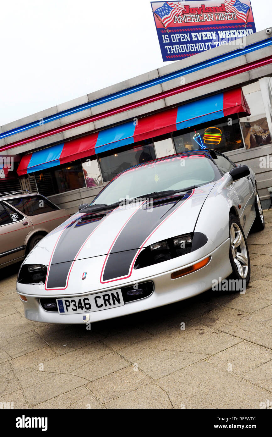 A silver fourth generation Chevrolet Camaro sports coupe from the late 1990's at a classic car meet in Great Yarmouth. Stock Photo