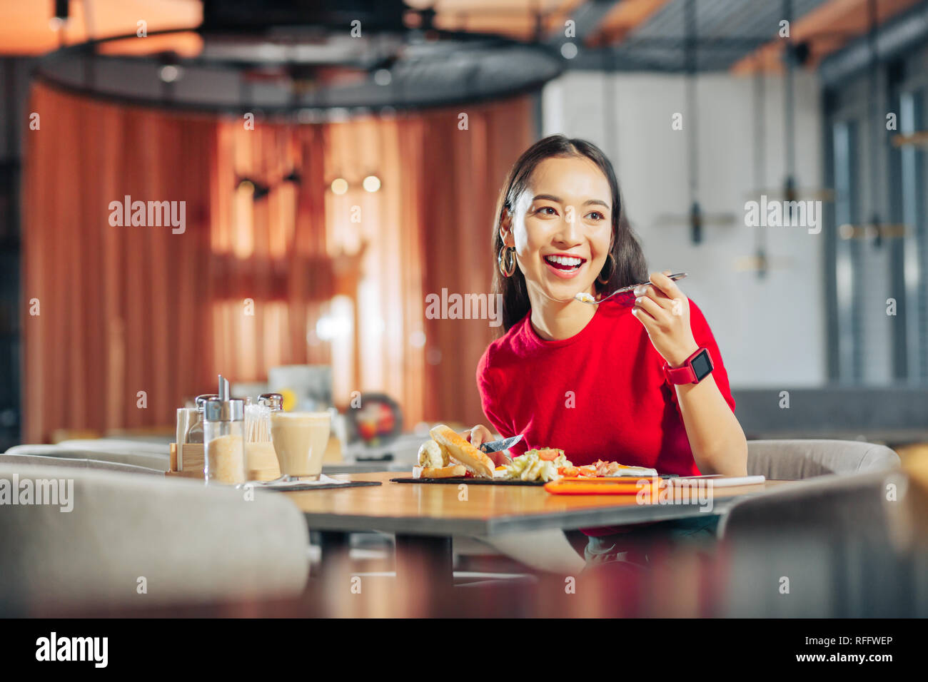 Dark-eyed woman feeling rested enjoying weekend breakfast Stock Photo
