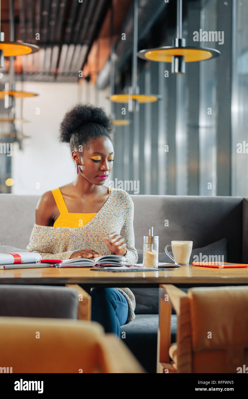 Stylish student feeling busy while studying and drinking coffee Stock Photo