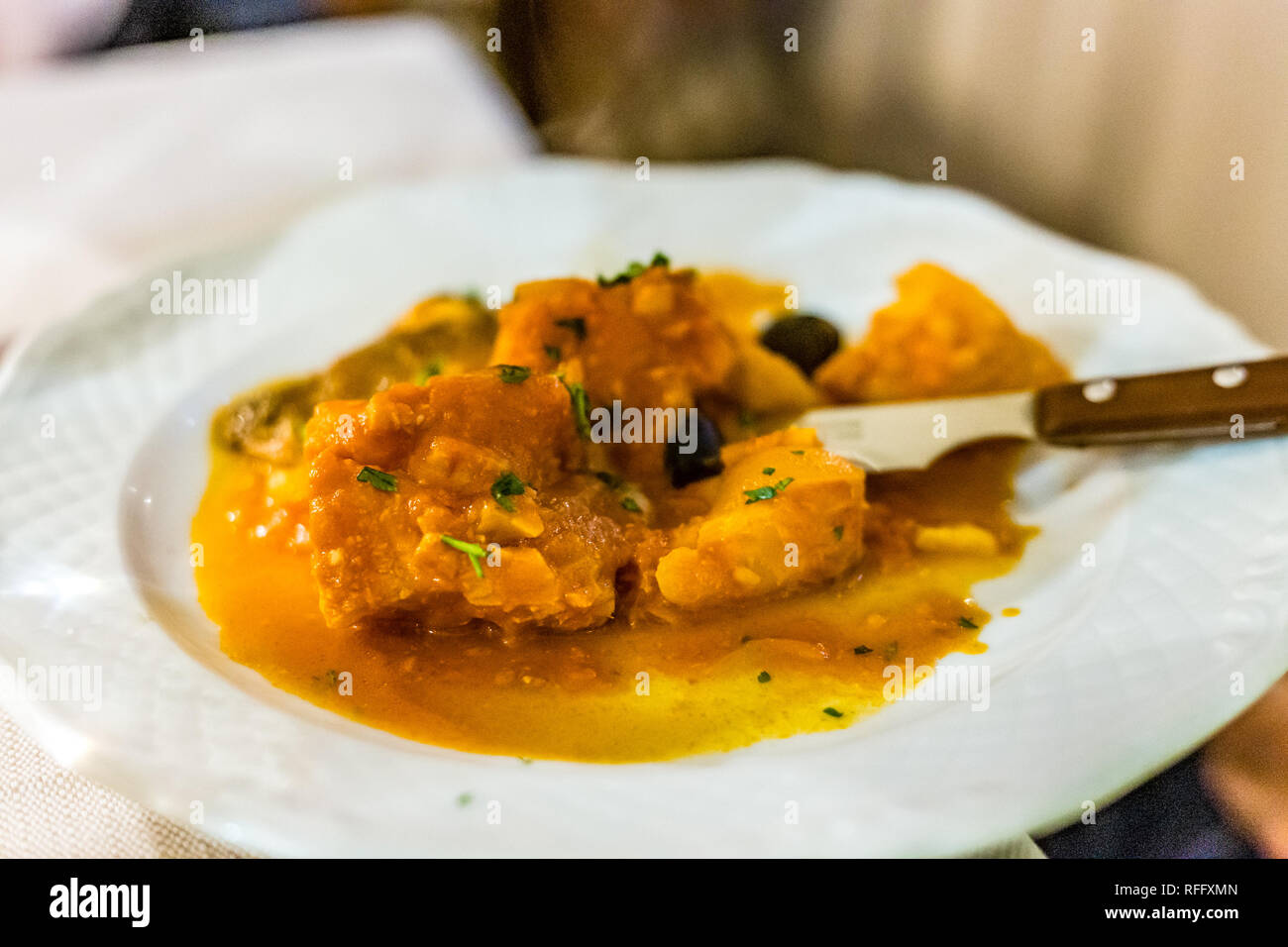 Salted codfish In tomato sauce in Italian restaurant Stock Photo Alamy