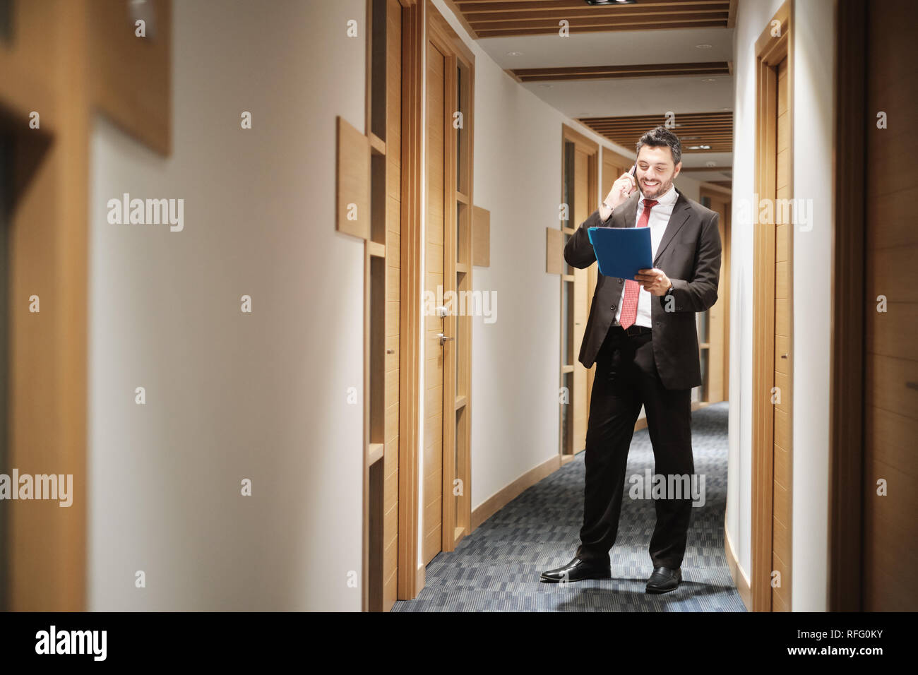 Hispanic Businessman At Work As Manager Talking On Cell Phone Stock Photo