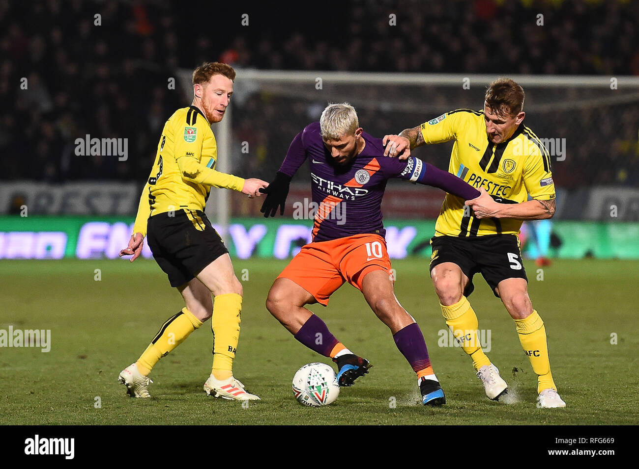 BURTON ON TRENT, UK 23 JANUARY. Manchester City striker Sergio Aguero (10)  battles with Burton Albion defender Kyle McFadzean (5) during the Carabao  Cup match between Burton Albion and Manchester City at