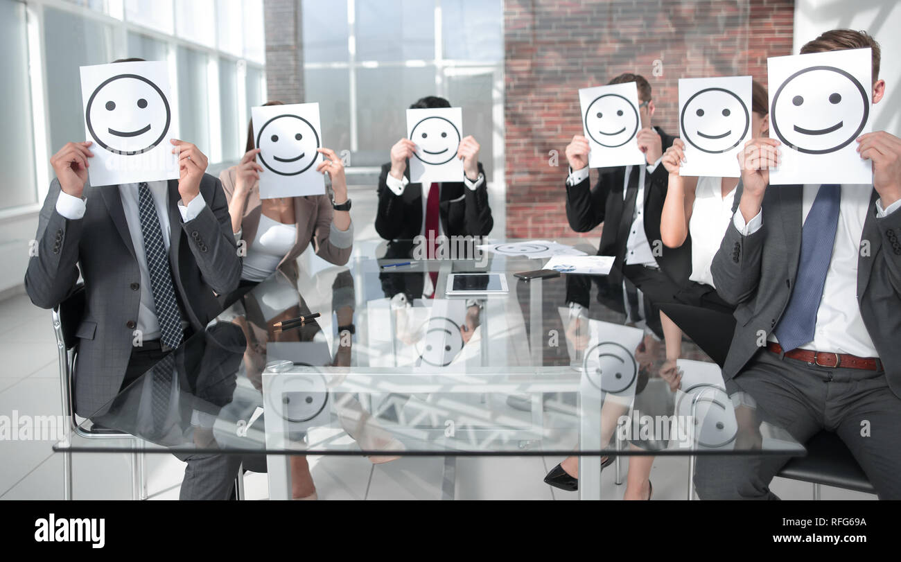Business Team holding a paper with a positive smiley Stock Photo