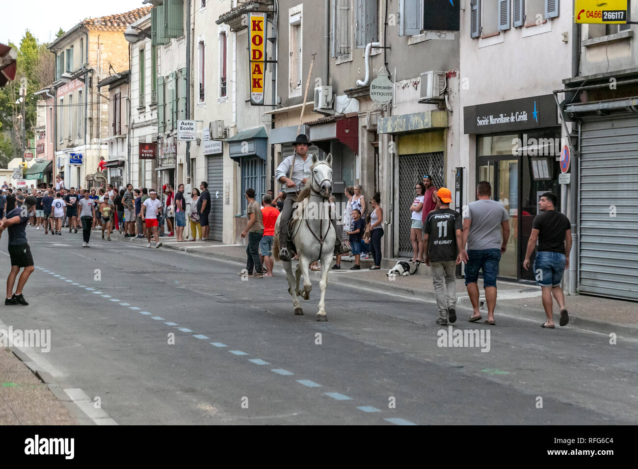 Gardian riding Camargue horse in the annual bull running fete, Saint Gilles, Gard, France Stock Photo