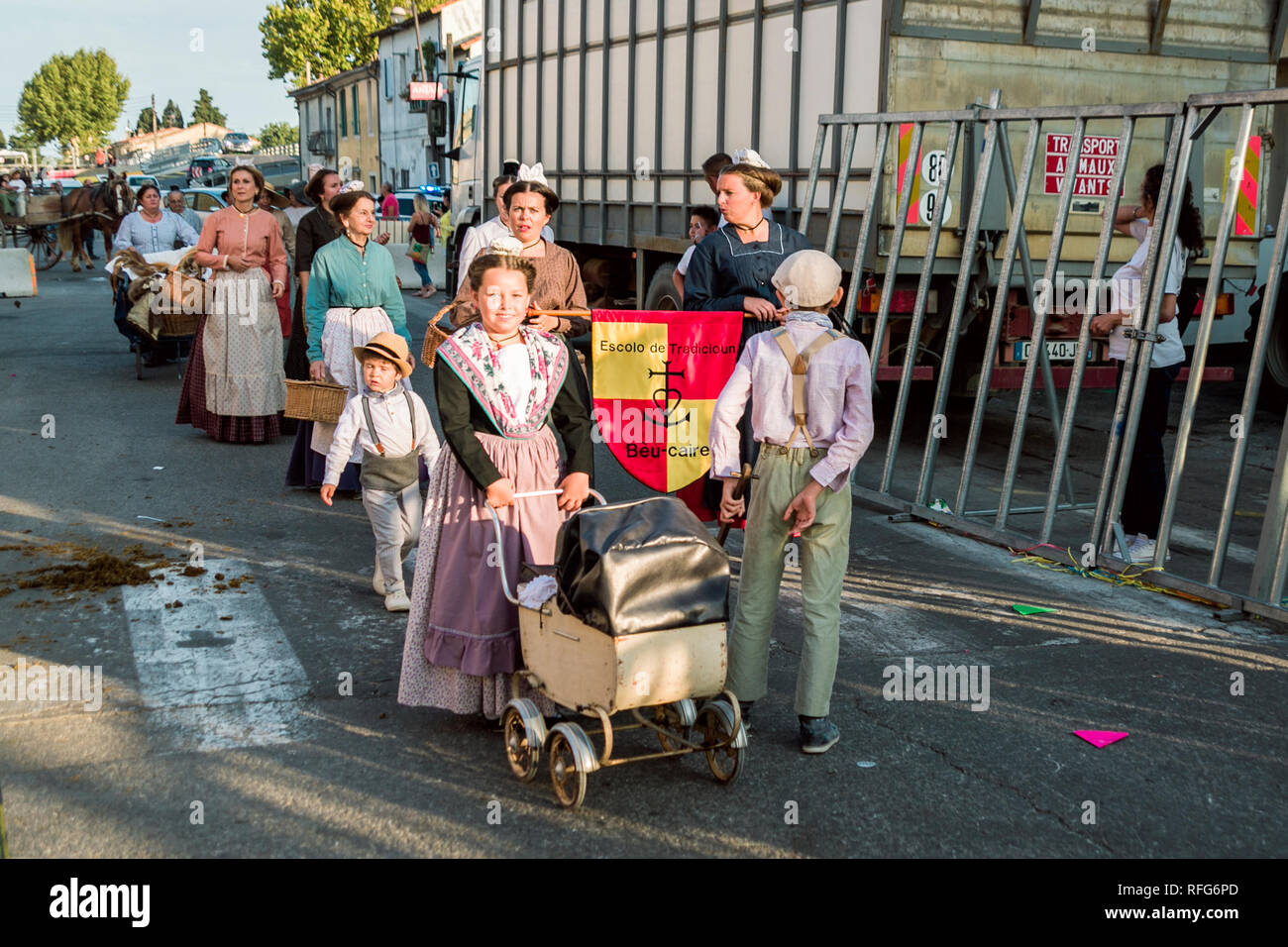 Women and children in traditonal costumes in the Old School Parade at the Annual Fete, Saint Gilles, Gard, France Stock Photo