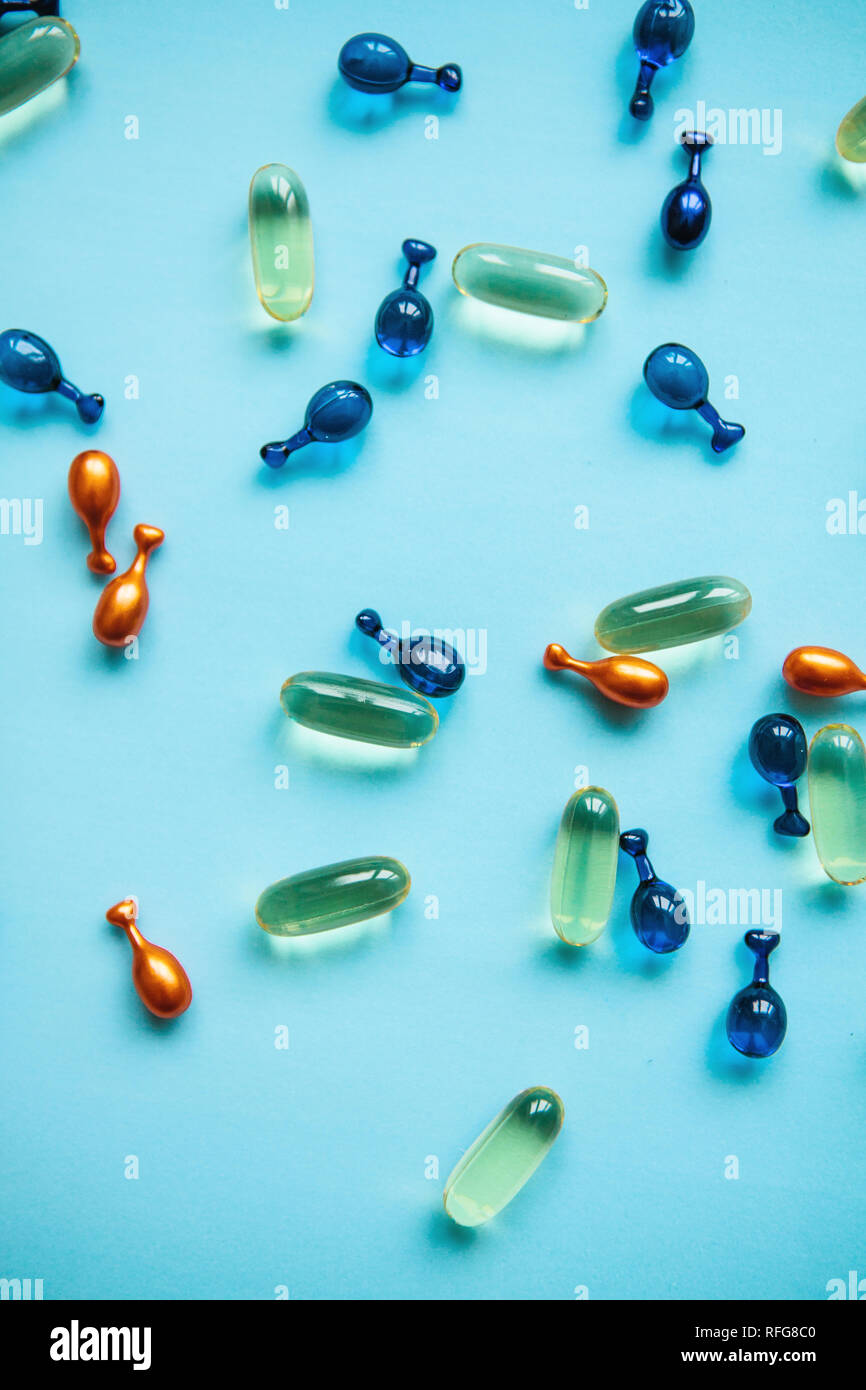 Capsule background with Omega 3, hyaluronic acid and coenzyme. Caring