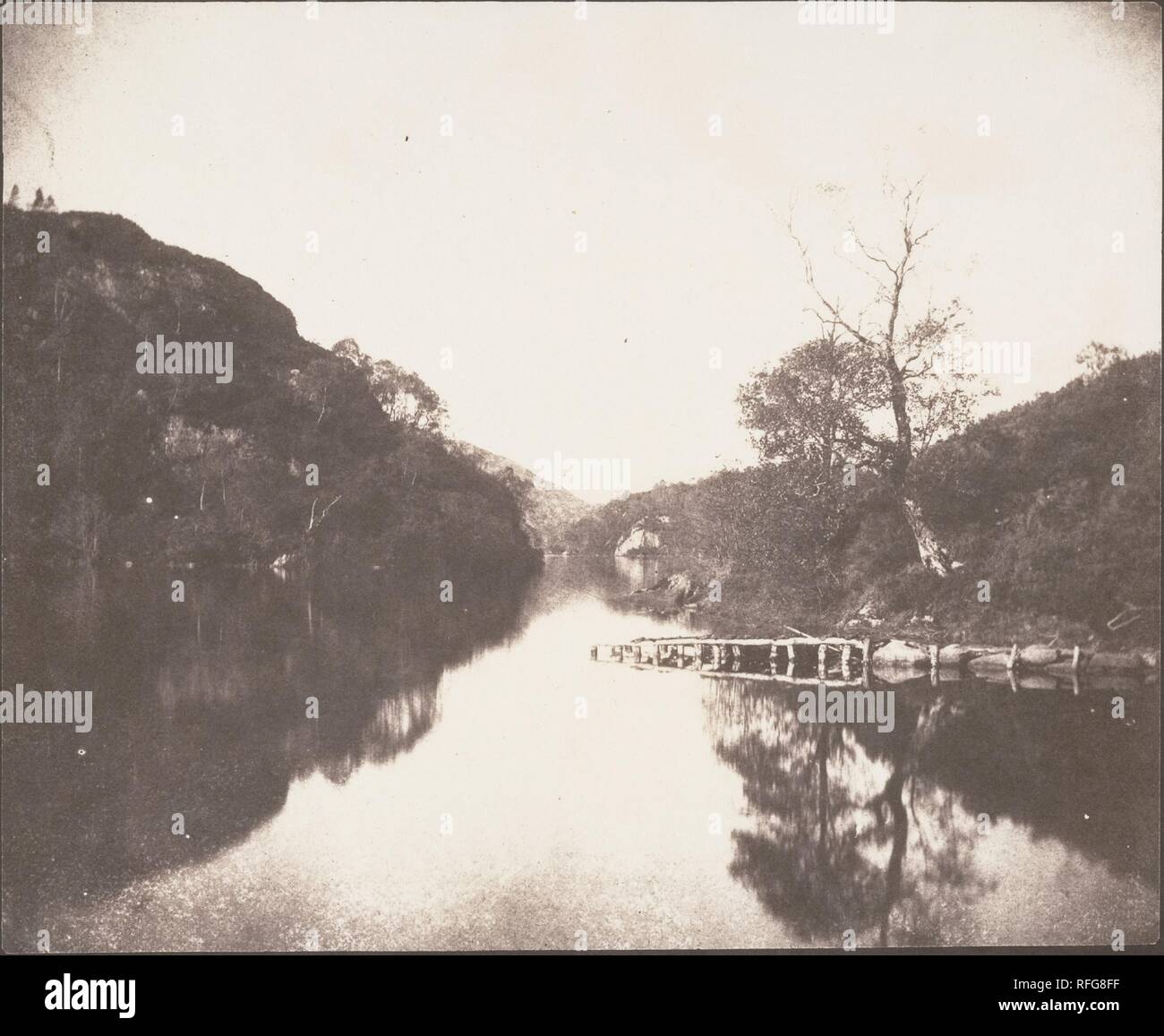 Loch Katrine Pier, Scene of the Lady of the Lake. Artist: William Henry Fox Talbot (British, Dorset 1800-1877 Lacock). Dimensions: Image: 17.5 x 21.1 cm (6 7/8 x 8 5/16 in.)  Sheet: 18.4 x 22.9 cm (7 1/4 x 9 in.). Date: October 1844.  Talbot, the quintessential gentleman amateur, took on a professional role in the publication of  two books illustrated with photographs: 'The Pencil of Nature', a general introduction to his invention, and 'Sun Pictures in Scotland', a tour of the scenery made popular by the novels of Sir Walter Scott.  This well-preserved print of Loch Katrine, perhaps the most  Stock Photo