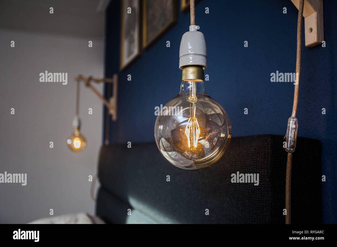 Decorative retro light bulbs against blue wall background, modern design Stock Photo