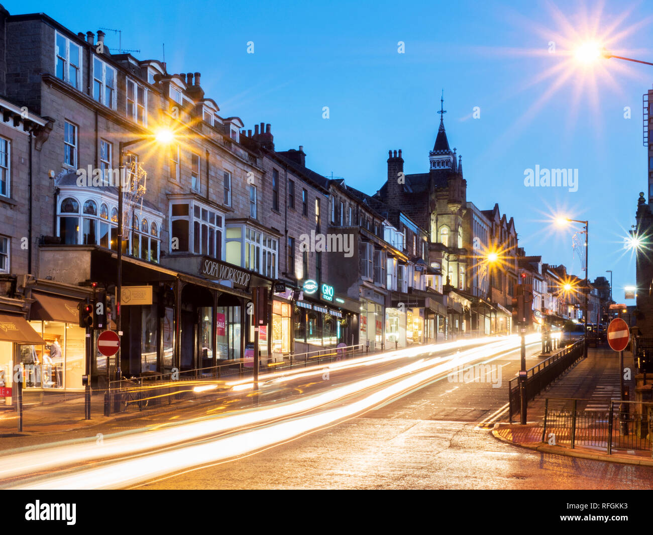 Traffic trails along Parliament Street at dusk Harrogate North Yorkshire England Stock Photo