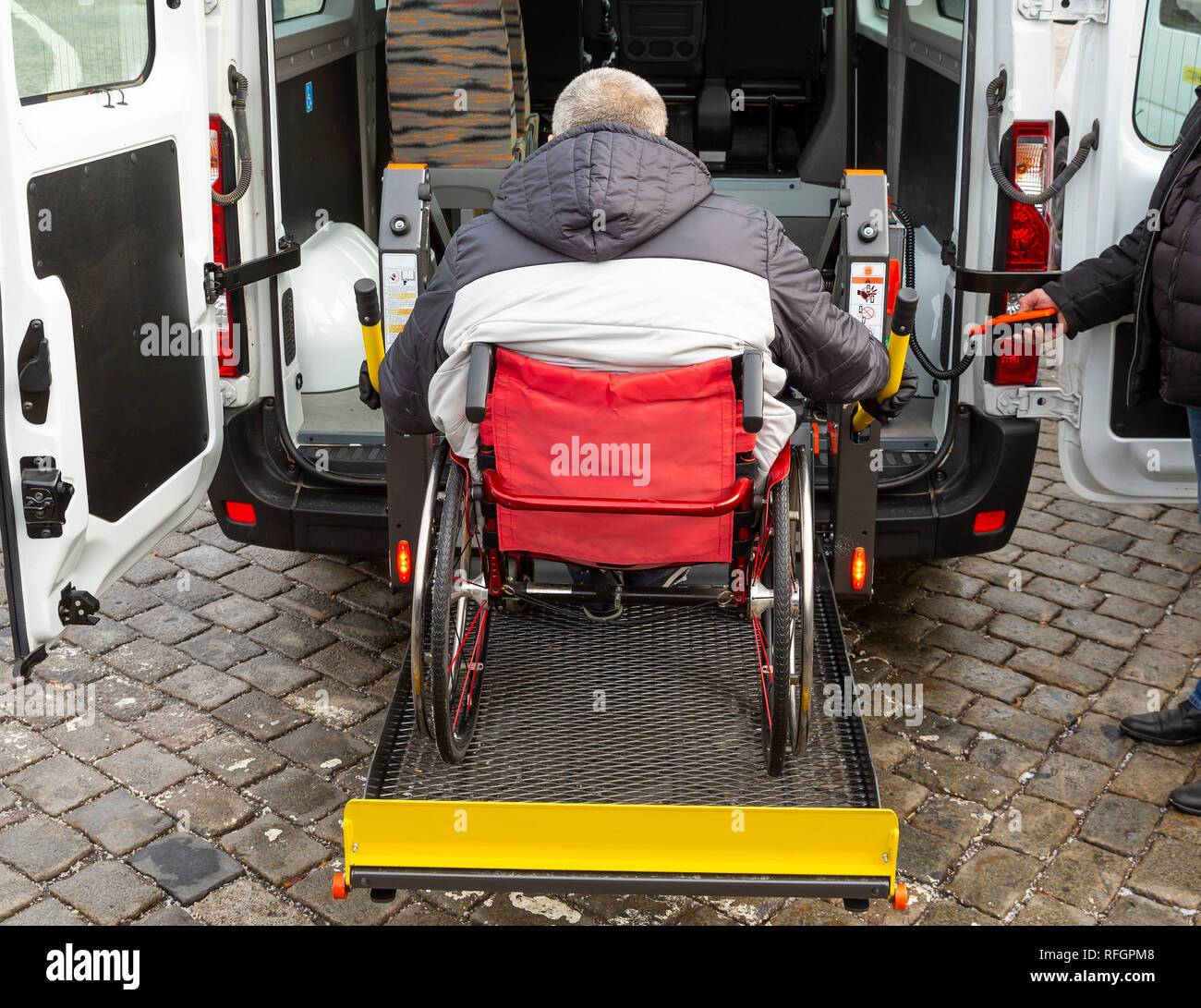 Minibus for handicapped, physically challenged and disabled people in wheelchairs. Minibus with stowed wheelchair ramp. Stock Photo