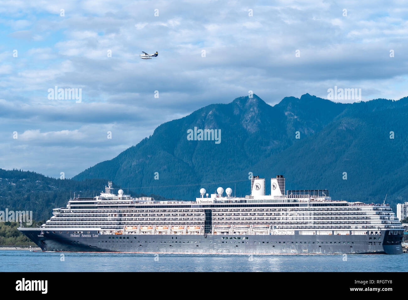Vancouver, Canada  - September 24 2017: Holland America Noordam Cruise Ship departing Vancouver with a Seaplane flying above Stock Photo