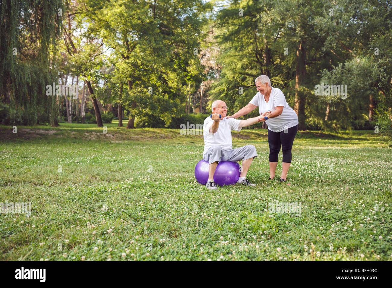 cardio exercise for senior- Happy mature family couple exercising outdoors. Stock Photo