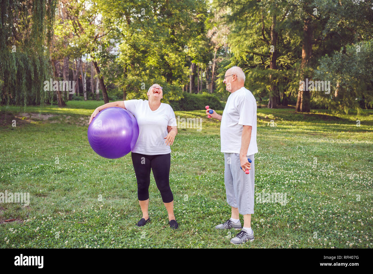 cardio exercise for senior- Happy senior woman with fitness balls in park and exercising Stock Photo