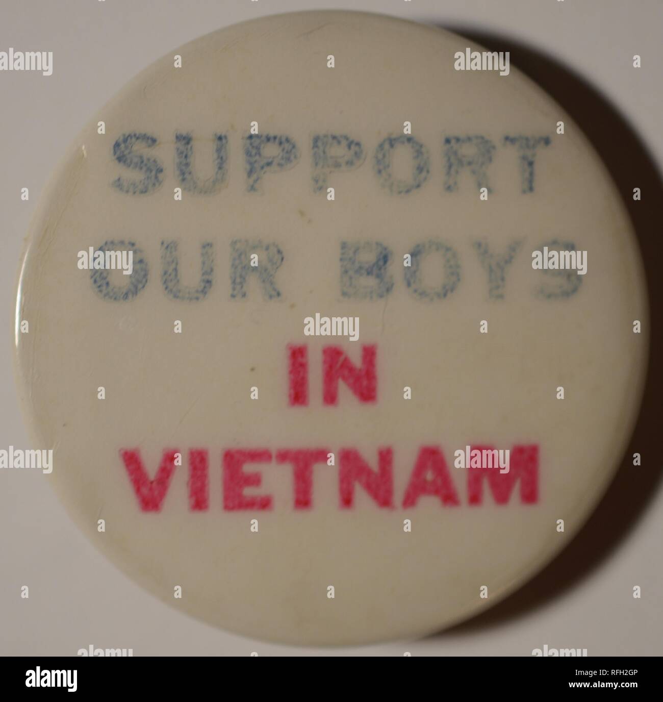 Red, white, and blue, pro-war, pin-back button or badge, with the text 'Support Our Boys In Vietnam,' manufactured during the Vietnam War, 1965. () Stock Photo