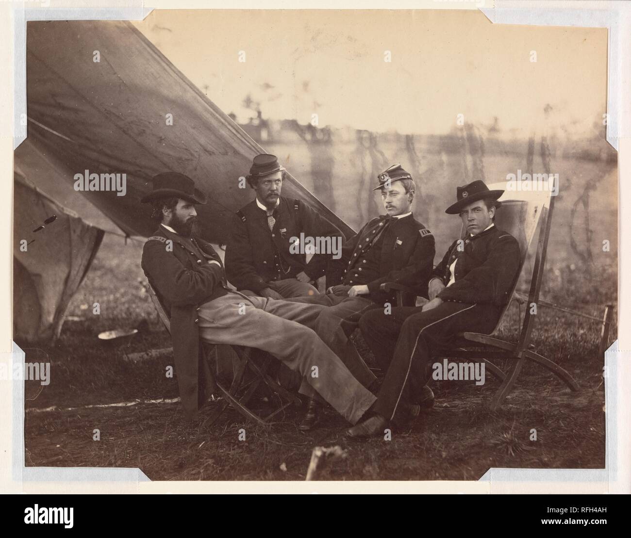 [Four Officers]. Artist: Alexander Gardner (American, Glasgow, Scotland 1821-1882 Washington, D.C.). Dimensions: Image: 17.8 x 22.8 cm (7 x 9 in.). Date: ca. 1864.  Gardner was an expert in the new wet-collodion-on-glass-plate process of photography and able manager of Mathew Brady's Washington, D.C., portrait studio from 1858 until 1862, when he had   a falling-out with his employer. In November 1862 he formed his own company, taking with him many of Brady's best photographers, including Egbert Guy Fowx (seen nearby). Like Brady, Gardner and his corps produced a vast photographic documentatio Stock Photo