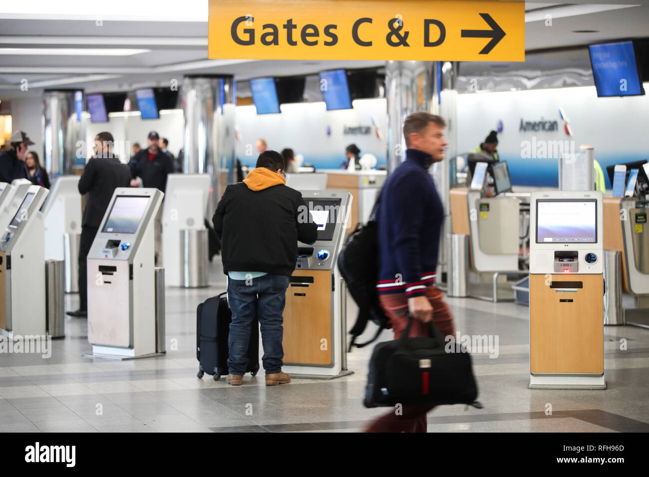 New York, USA. 25th Jan, 2019. A passenger uses a self-service kiosk to check in at the LaGuardia Airport in New York, the United States, on Jan. 25, 2019. The U.S. Federal Aviation Administration on Friday halted flights bound for New York City's LaGuardia Airport, due to staff shortage caused by the historic government shutdown. Credit: Wang Ying/Xinhua/Alamy Live News Stock Photo