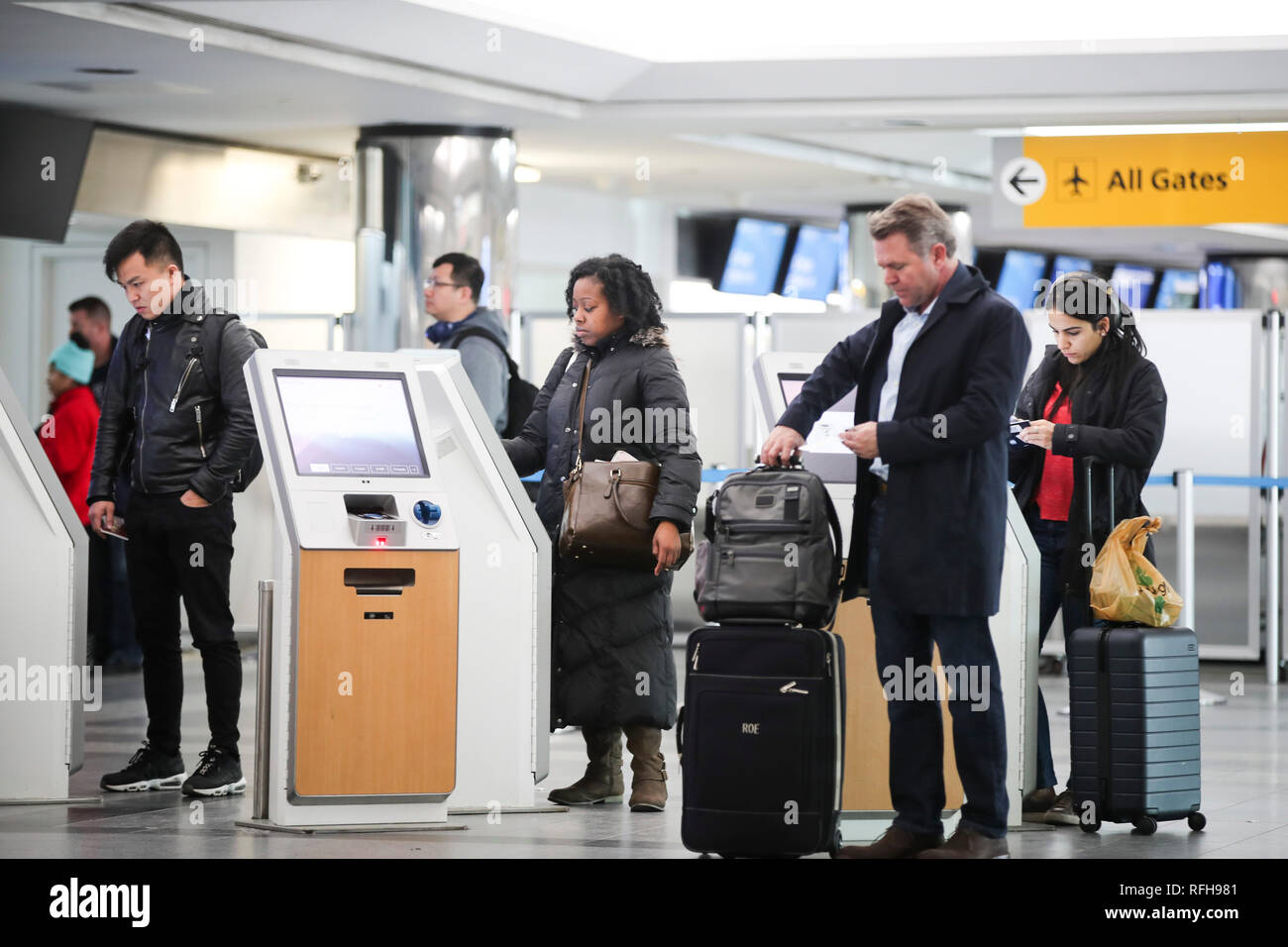 New York, USA. 25th Jan, 2019. Passengers use self-service kiosks to check in at the LaGuardia Airport in New York, the United States, on Jan. 25, 2019. The U.S. Federal Aviation Administration on Friday halted flights bound for New York City's LaGuardia Airport, due to staff shortage caused by the historic government shutdown. Credit: Wang Ying/Xinhua/Alamy Live News Stock Photo