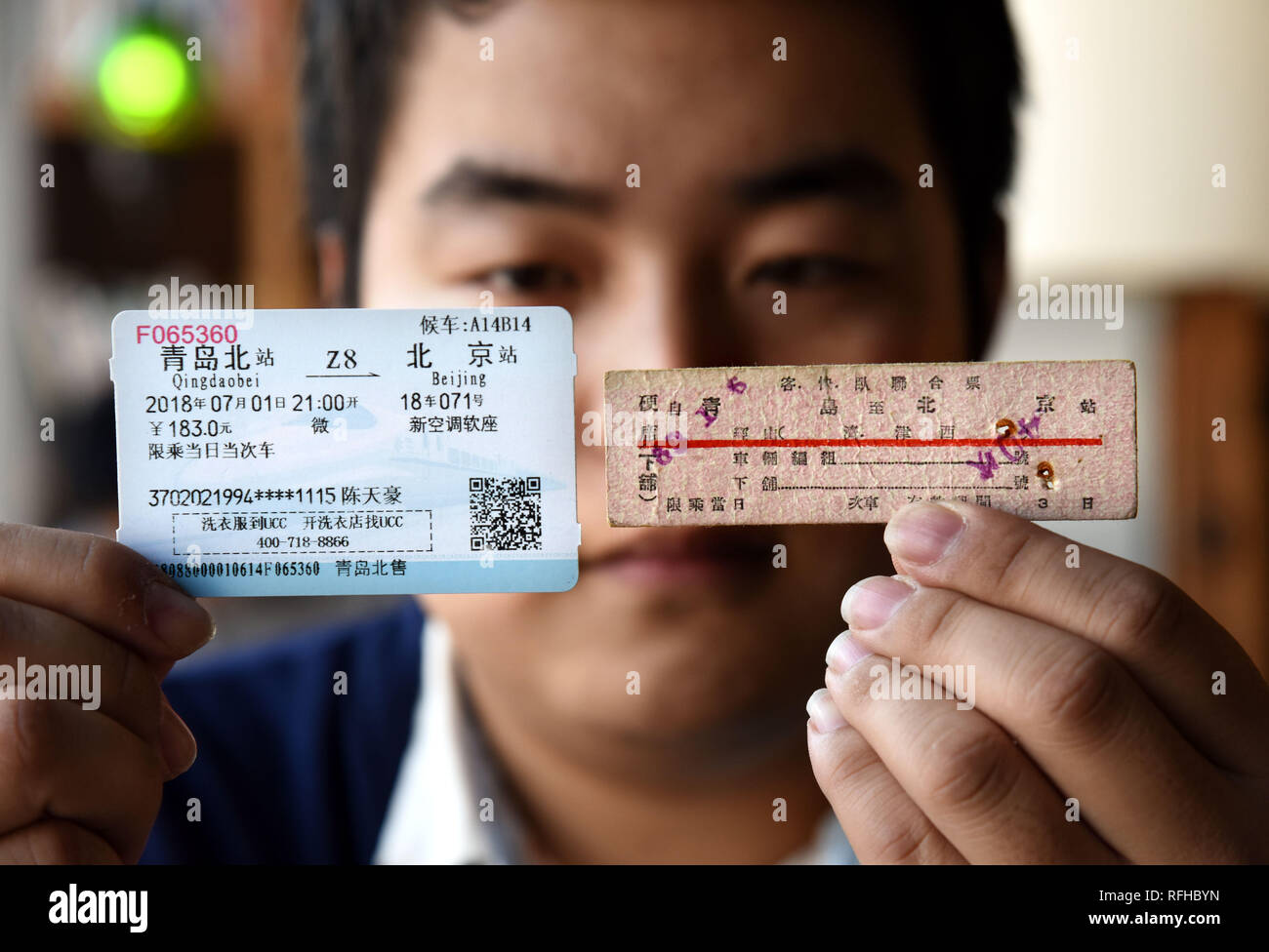 Beijing, China's Shandong Province. 25th Jan, 2019. Railway enthusiast Chen Tianhao juxtaposes a 1962 Chinese train ticket (R) with the one issued in 2018, Qingdao, east China's Shandong Province, Jan. 25, 2019. Credit: Li Ziheng/Xinhua/Alamy Live News Stock Photo