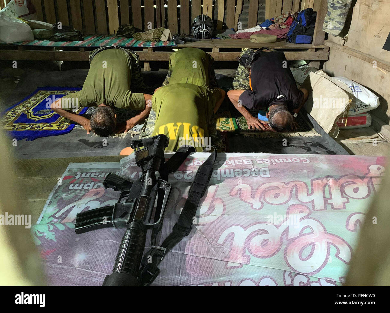 Maguindanao, Philippines. 26th January 2019.  Filipino Muslim rebels pray inside their detachment in Sultan Kudarat town in Maguindanao in the southern Philippines, Saturday, January 26, 2019, a day after the Comelec announced Bangsamoro Organic Law (BOL) was “deemed ratified,” as officials released figures showing that more than 1.5 million registered voters had cast “yes” ballots for the law’s ratification versus nearly 200,000 who had voted against it.  The law aims to give the impoverished south an expanded autonomous area. Credit: Jeoffrey Maitem/Alamy Live News Stock Photo