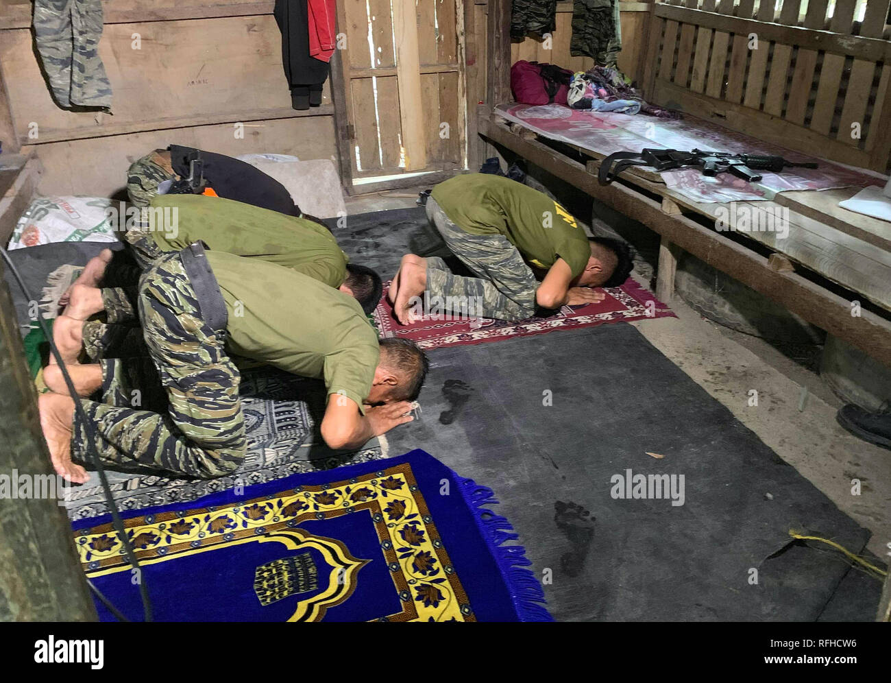 Maguindanao, Philippines. 26th January 2019. Filipino Muslim rebels pray inside their detachment in Sultan Kudarat town in Maguindanao in the southern Philippines, Saturday, January 26, 2019, a day after the Comelec announced Bangsamoro Organic Law (BOL) was “deemed ratified,” as officials released figures showing that more than 1.5 million registered voters had cast “yes” ballots for the law’s ratification versus nearly 200,000 who had voted against it.  The law aims to give the impoverished south an expanded autonomous area. Credit: Jeoffrey Maitem/Alamy Live News Stock Photo