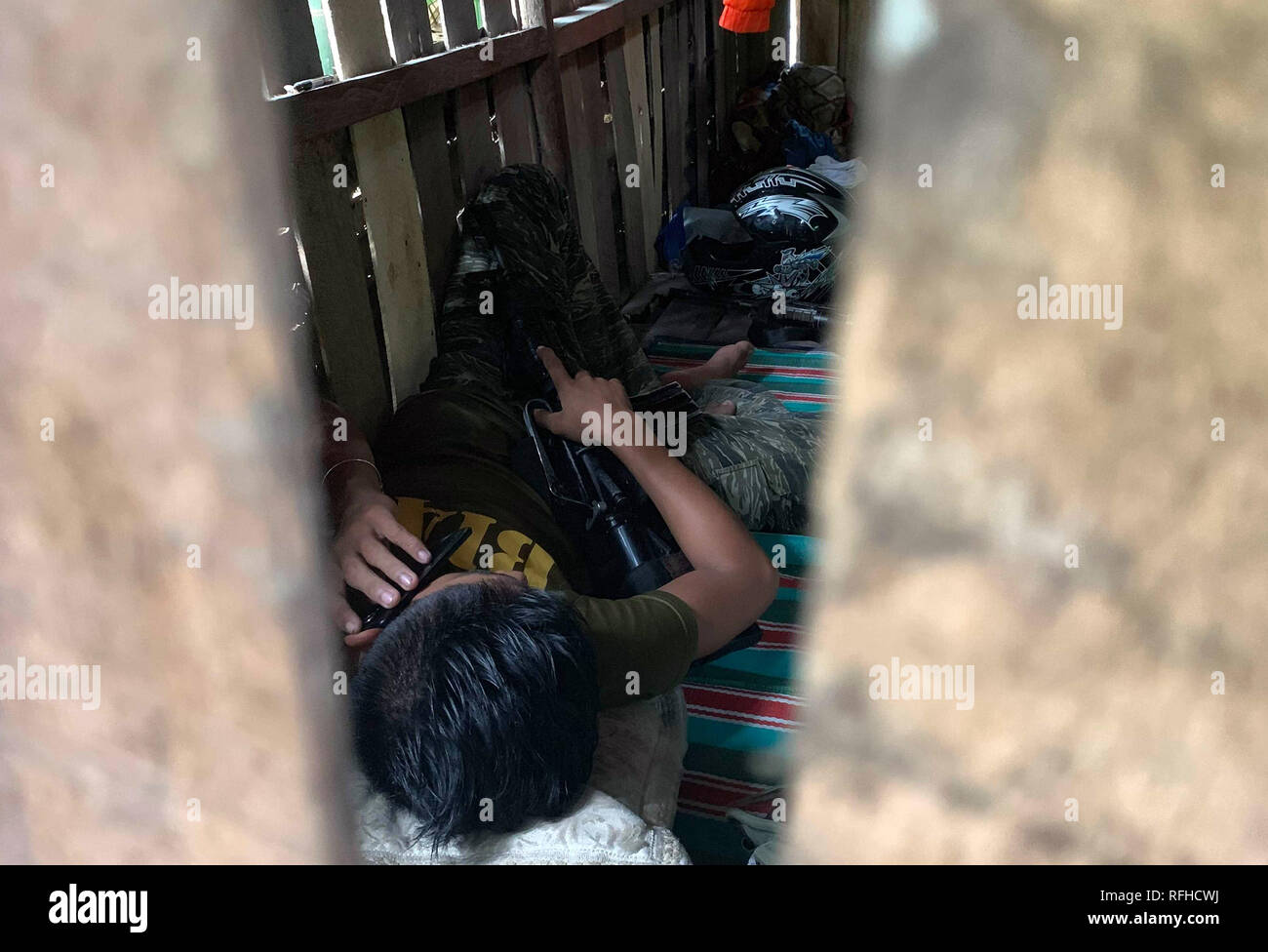 Maguindanao, Philippines. 26th January 2019. A Filipino Muslim rebel is seen inside their detachment in Sultan Kudarat town in Maguindanao in the southern Philippines, Saturday, January 26, 2019 as the Comelec announced Bangsamoro Organic Law (BOL) was “deemed ratified,” as officials released figures showing that more than 1.5 million registered voters had cast “yes” ballots for the law’s ratification versus nearly 200,000 who had voted against it.  The law aims to give the impoverished south an expanded autonomous area. Credit: Jeoffrey Maitem/Alamy Live News Stock Photo