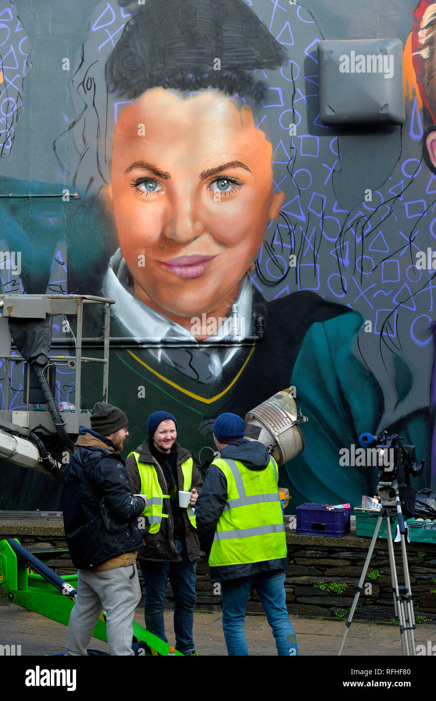 Londonderry, Northern Ireland. 26th January 2019. Graffiti artists on a tea break during the painting the main characters from the hit Channel 4 comedy show, Derry Girls, who are being immortalised in a new mural on the gable end of Badgers Bar & Restaurant in Orchard Street in Londonderry’s city centre. The mural, developed by Channel 4’s in-house creative agency, 4Creative, and painted by locally based UV Arts group depicts the main characters, Erin, Orla, Clare, Michelle and James. Credit: George Sweeney/Alamy Live News Stock Photo