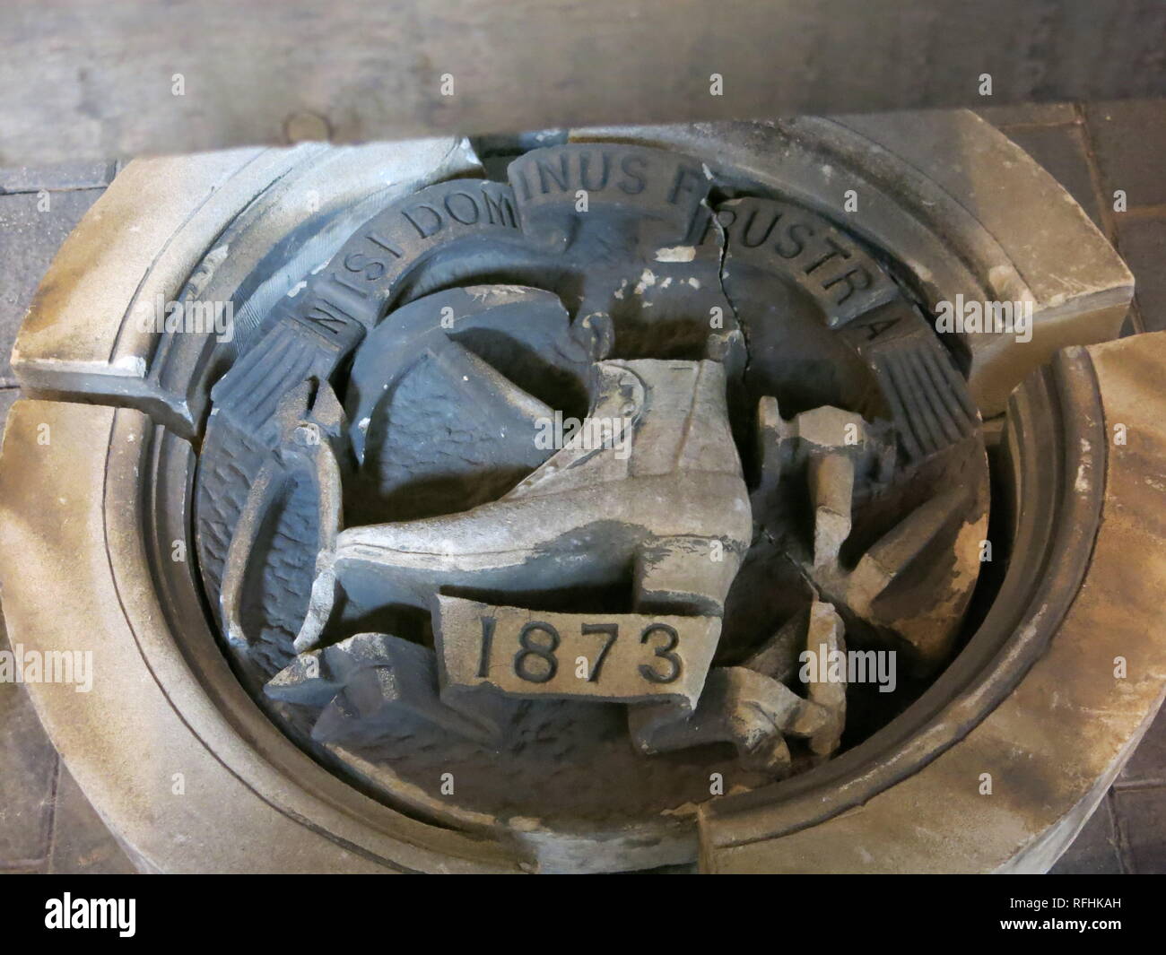 The motto 'nisi dominus frustra' is inscribed above a boot with the date 1873 in an artefact at the Manor House Museum' boot & shoe exhibition Stock Photo