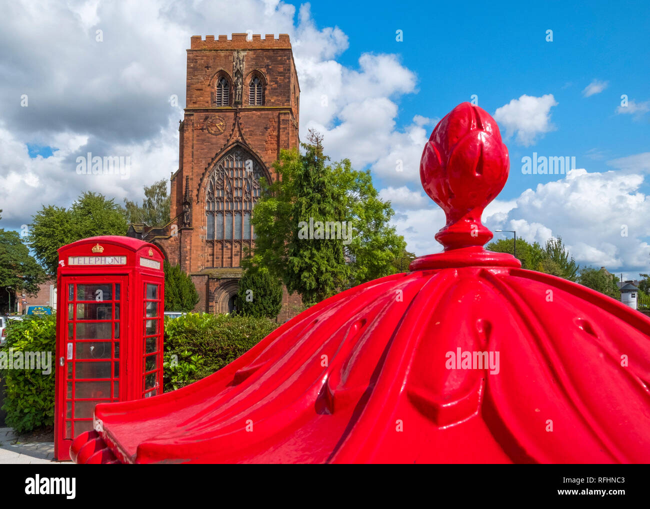 Shrewsbury Abbey with a red phone box and Penfold pillar box, Shropshire, England, UK Stock Photo