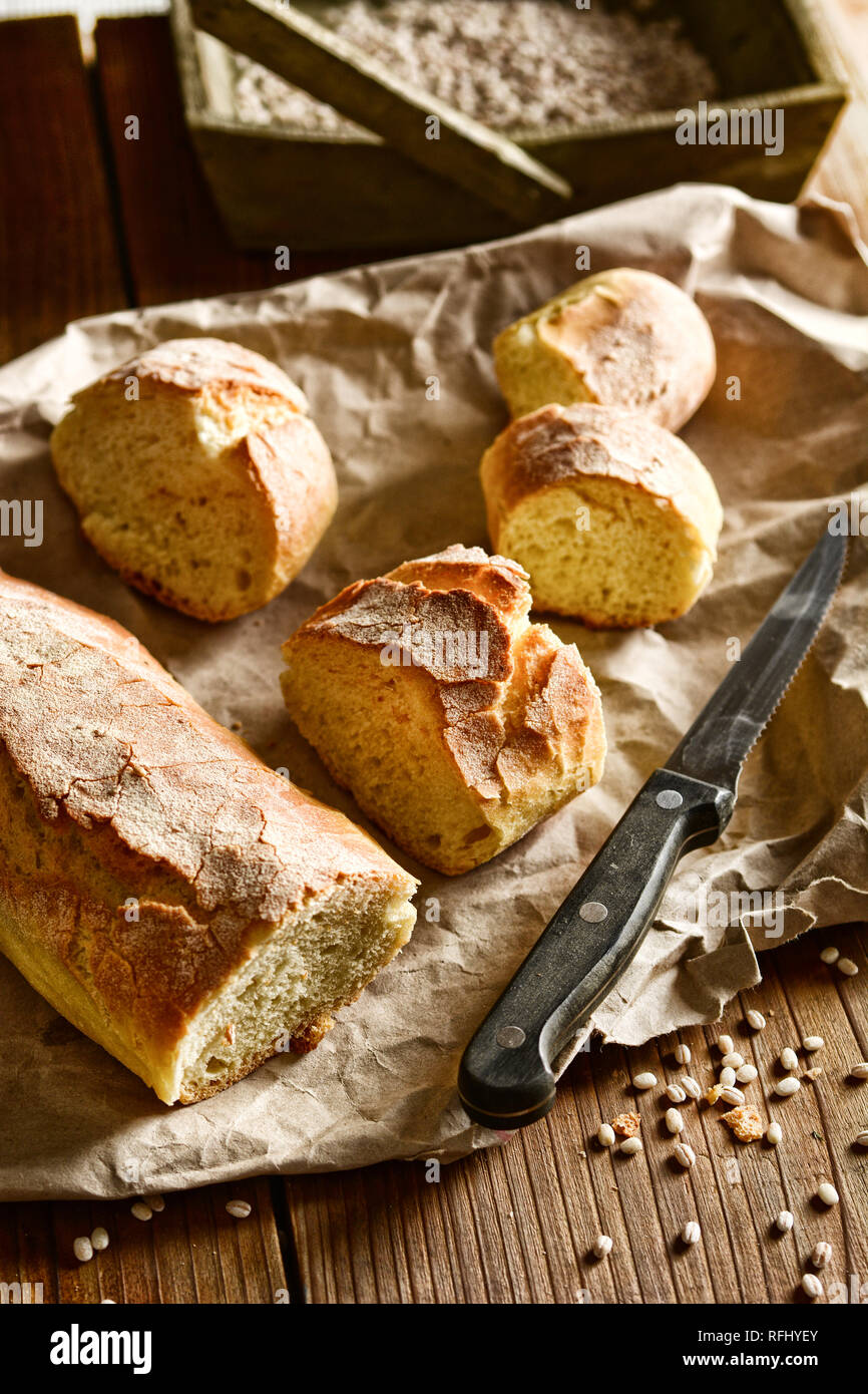hot sliced bread on wooden table - rustic effect - closeup Stock Photo
