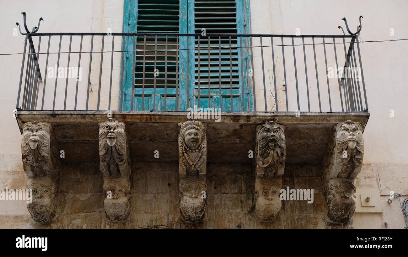 Incredible details in a balcony of Noto, a city in the province of Syracuse, Sicily. This style of arquitecture is known as sicilian baroque. Stock Photo