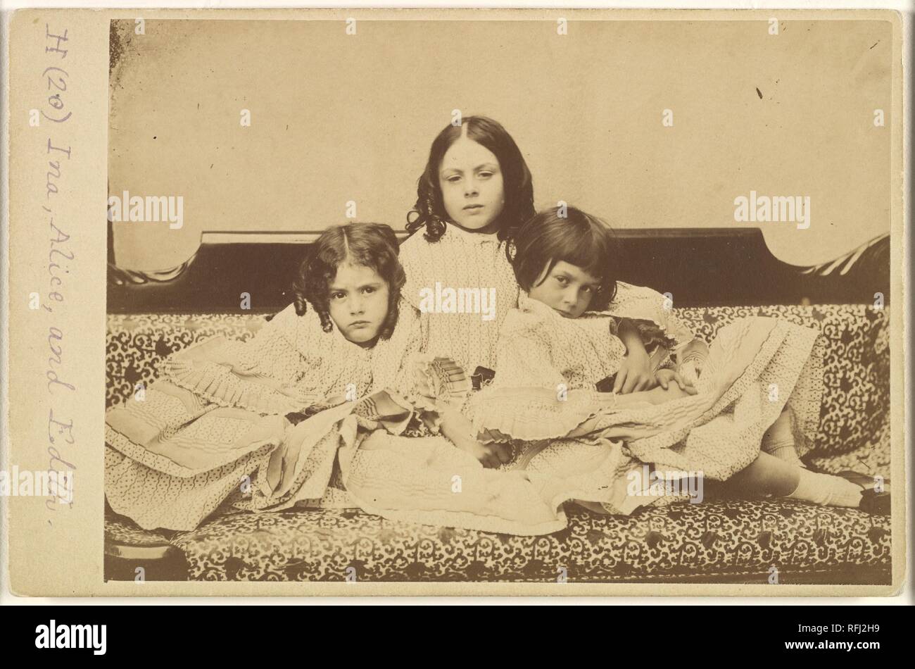 Edith, Ina and Alice Liddell on a Sofa. Artist: Lewis Carroll (British, Daresbury, Cheshire 1832-1898 Guildford). Dimensions: Mount: 4 3/16 in. × 6 7/16 in. (10.7 × 16.3 cm)  Image: 4 1/16 × 6 1/16 in. (10.3 × 15.4 cm). Person in Photograph: Person in photograph Alice Pleasance Liddell (British, 1852-1934); Person in photograph Edith Mary Liddell (British, 1854-1876); Person in photograph Ina Liddell (British, 1849-1930). Date: Summer 1858. Museum: Metropolitan Museum of Art, New York, USA. Stock Photo