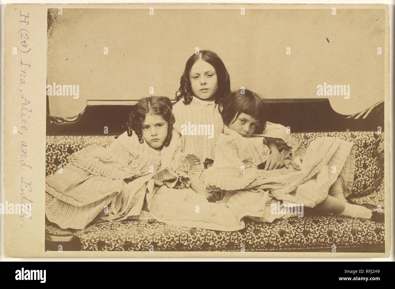 Edith, Ina and Alice Liddell on a Sofa. Artist: Lewis Carroll (British, Daresbury, Cheshire 1832-1898 Guildford). Dimensions: Mount: 4 3/16 in. × 6 7/16 in. (10.7 × 16.3 cm) Image: 4 1/16 × 6 1/16 in. (10.3 × 15.4 cm). Person in Photograph: Person in photograph Alice Pleasance Liddell (British, 1852-1934); Person in photograph Edith Mary Liddell (British, 1854-1876); Person in photograph Ina Liddell (British, 1849-1930). Date: Summer 1858. Museum: Metropolitan Museum of Art, New York, USA. Stock Photo