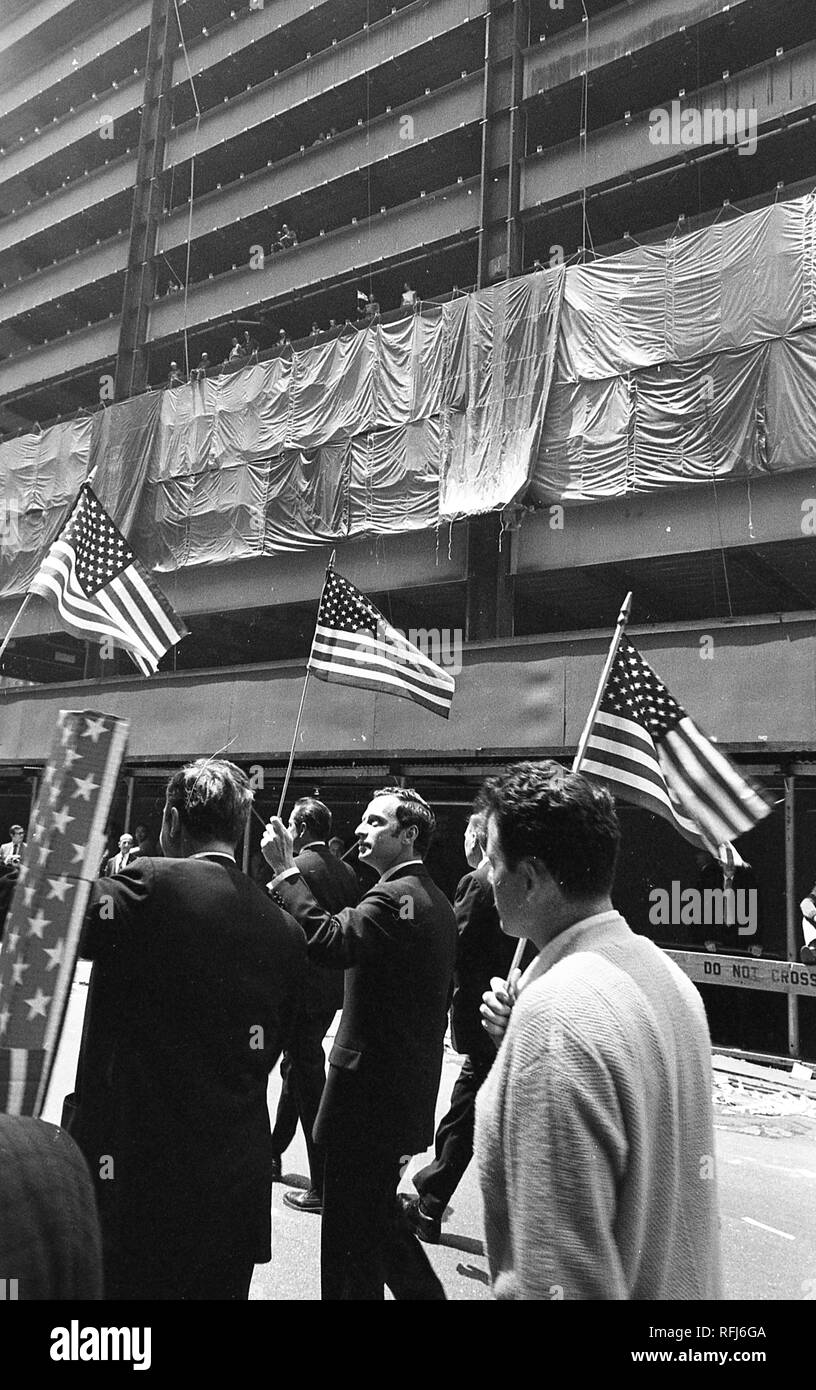 Demonstrators are viewed from behind while participating in protests