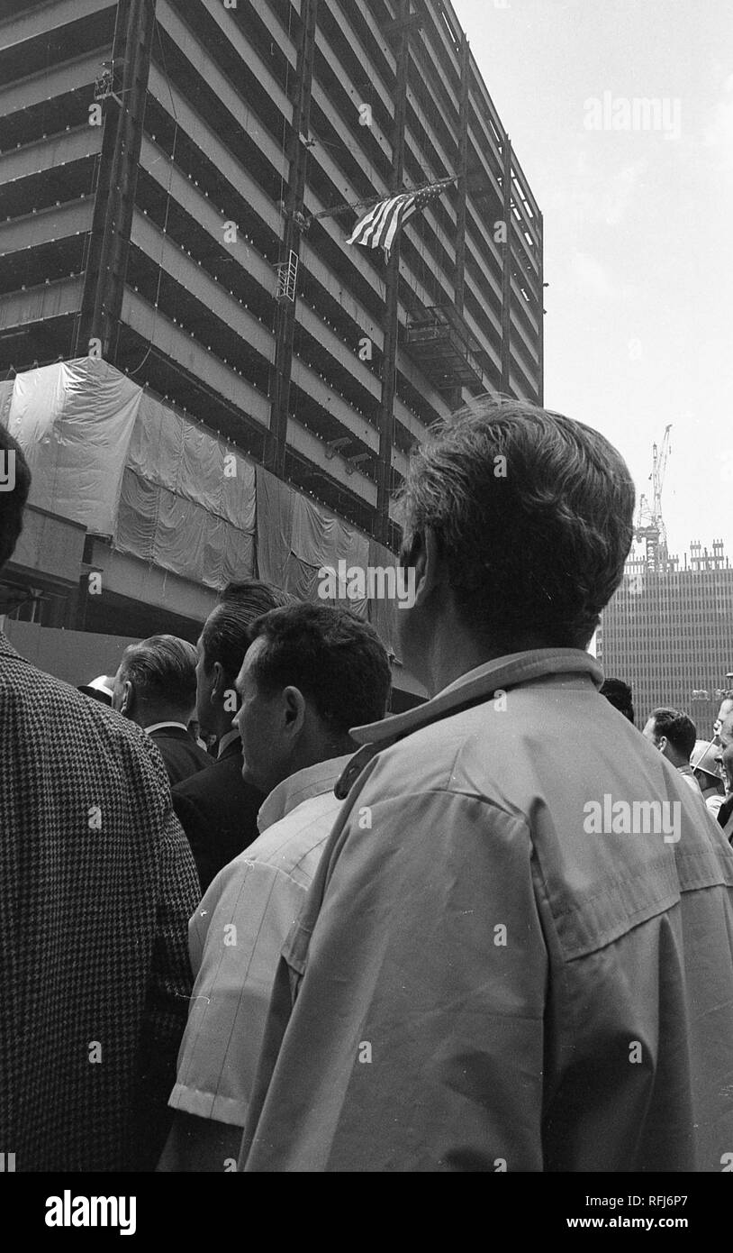 Demonstrators are viewed from behind while participating in protests