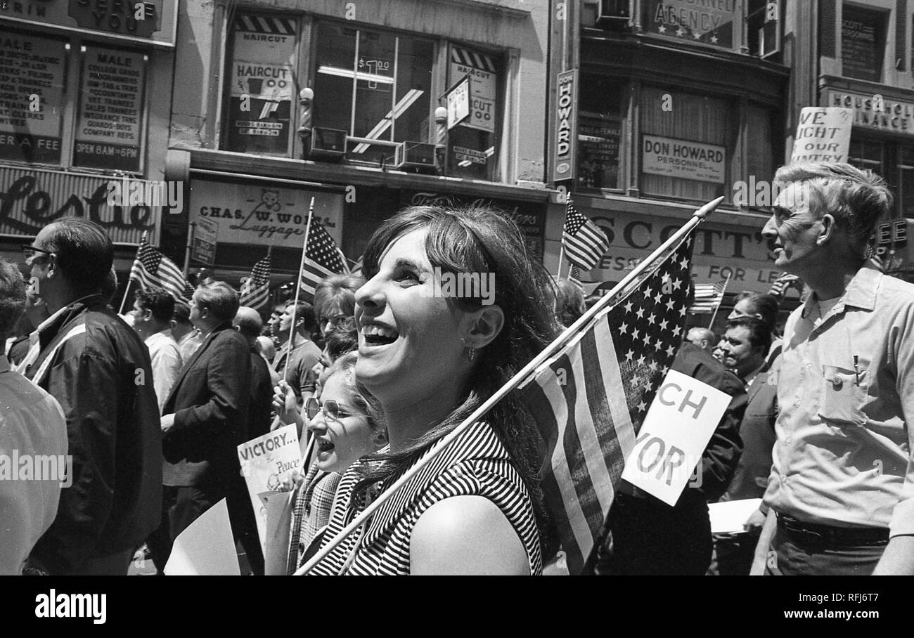 Demonstrators march and hold banners and flags while participating in