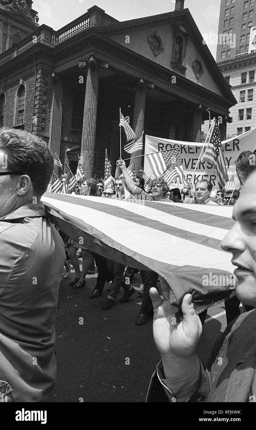 Demonstrators march and hold banners and flags while participating in protests related to the anti-Vietnam War Hard Hat Riot, New York City, New York, May 1970. () Stock Photo