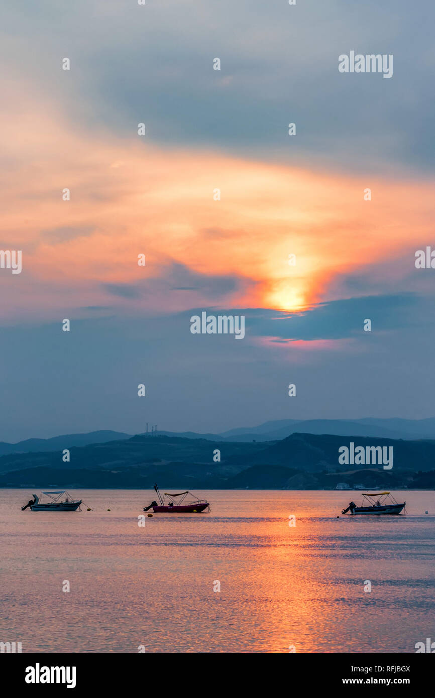 Sunset view of the Mediterranean sea and boats in Halkidiki, Greece. Stock Photo