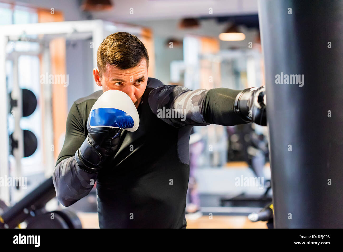 Male boxer does jab punch in modern gym Stock Photo Alamy