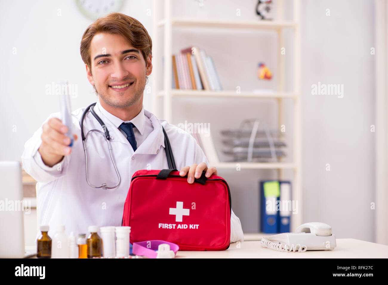 Young doctor with first aid kit in hospital Stock Photo Alamy