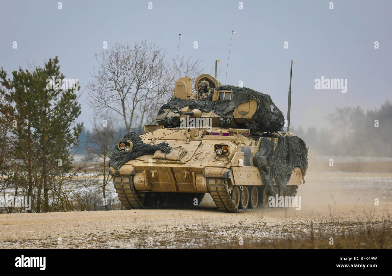 A U.S. Army Bradly Crew assigned to 2nd Battalion 5th Cavalry Regiment, 1st Armored Brigade Combat Team, 1st Cavalry Division hurry to their next position during the gunnery portion of Combined Resolve XI Phase II in Grafenwoehr, Germany Jan. 23, 2019. CBRXI Phase II is the culminating exercise for 1-1 CD's rotation in support of Atlantic Resolve, an enduring exercise that helps builds interoperability between U.S. Forces, their NATO allies and partners.  (U.S. Army National Guard photo by Sgt. 1st Class Ron Lee, 382nd Public Affairs Detachment, 1ABCT, 1CD released) Stock Photo