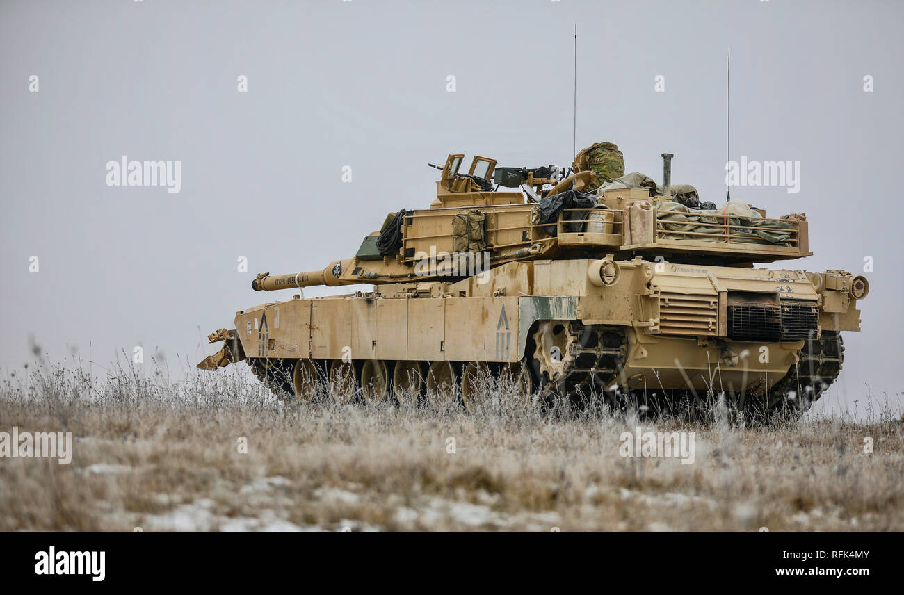 A U.S. Army M1A1 Tank Crew assigned to 2nd Battalion 5th Cavalry Regiment, 1st Armored Brigade Combat Team, 1st Cavalry Division set up a defensive position during the gunnery portion of Combined Resolve XI Phase II in Grafenwoehr, Germany Jan. 23, 2019. CBRXI Phase II is the culminating exercise for 1-1 CD's rotation in support of Atlantic Resolve, an enduring exercise that helps builds interoperability between U.S. Forces, their NATO allies and partners.  (U.S. Army National Guard photo by Sgt. 1st Class Ron Lee, 382nd Public Affairs Detachment, 1ABCT, 1CD released) Stock Photo