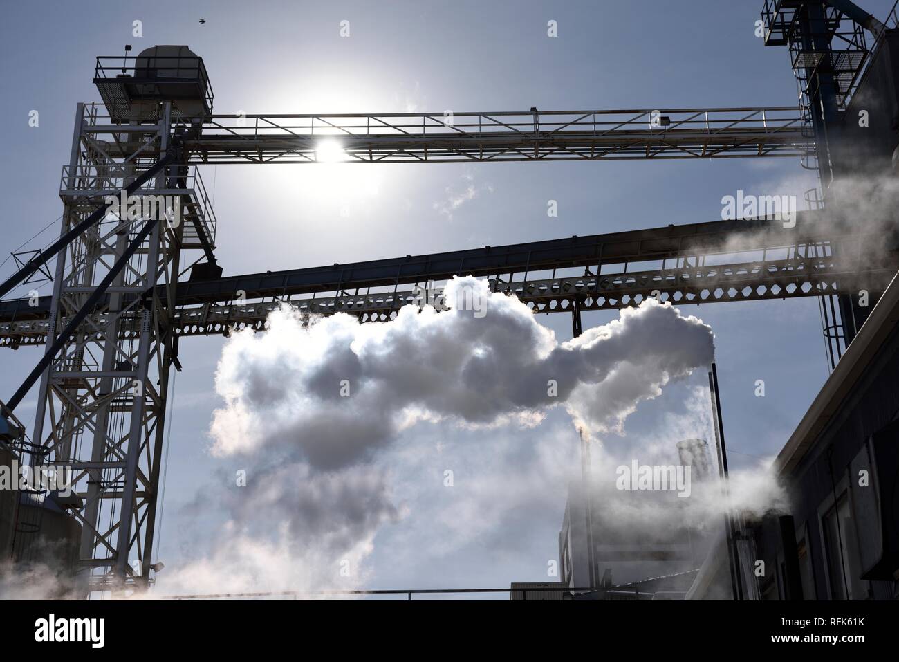 Metal factory tower structures, bridges and steam emissions looking